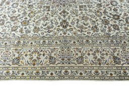 Corner detail of 2000s Kashan rug showing border pattern and Wool pile