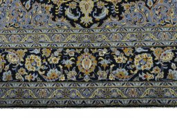 Corner detail of 2000s Kashan rug showing border pattern and Wool pile