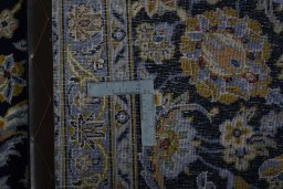 Backside of handmade 2000s Kashan rug showing knot structure and weave density