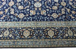 Corner detail of 2000s Kashan rug showing border pattern and Wool pile