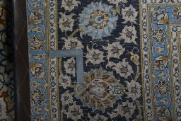 Backside of handmade 2000s Kashan rug showing knot structure and weave density