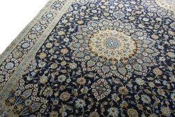 Backside of handmade 2000s Kashan rug showing knot structure and weave density
