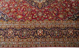 Corner detail of 2000s Kashan rug showing border pattern and Wool pile