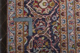 Backside of handmade 2000s Kashan rug showing knot structure and weave density