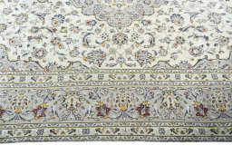 Corner detail of 2000s Kashan rug showing border pattern and Wool pile