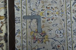 Backside of handmade 2000s Kashan rug showing knot structure and weave density