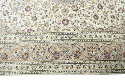 Corner detail of 2000s Kashan rug showing border pattern and Wool pile
