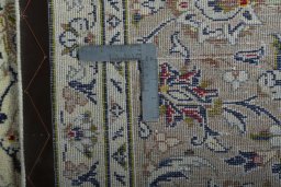 Backside of handmade 2000s Kashan rug showing knot structure and weave density