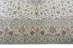 Corner detail of 2000s Kashan rug showing border pattern and Wool pile