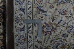 Backside of handmade 2000s Kashan rug showing knot structure and weave density