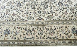 Corner detail of 2000s Kashan rug showing border pattern and Wool pile