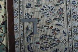 Backside of handmade 2000s Kashan rug showing knot structure and weave density