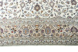 Corner detail of 2000s Kashan rug showing border pattern and Wool pile