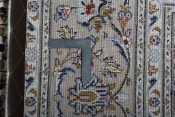 Backside of handmade 2000s Kashan rug showing knot structure and weave density