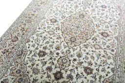Backside of handmade 2000s Kashan rug showing knot structure and weave density