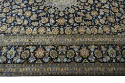 Corner detail of 2000s Kashan rug showing border pattern and Wool pile