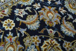 Close-up detail of 2000s Kashan rug from Iran / Persia showing Wool weave