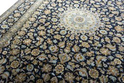 Backside of handmade 2000s Kashan rug showing knot structure and weave density