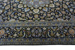Corner detail of New Kashan rug showing border pattern and Wool pile