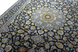 Backside of handmade New Kashan rug showing knot structure and weave density