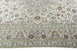 Corner detail of 2000s Kashan rug showing border pattern and Wool pile
