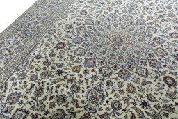 Backside of handmade New Kashan rug showing knot structure and weave density