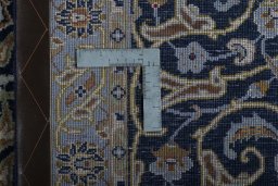 Backside of handmade 2000s Kashan rug showing knot structure and weave density