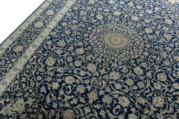 Backside of handmade 2000s Kashan rug showing knot structure and weave density