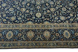 Corner detail of 2000s Kashan rug showing border pattern and Wool pile