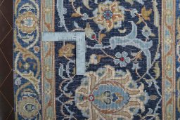 Backside of handmade 2000s Kashan rug showing knot structure and weave density