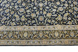 Corner detail of 2000s Kashan rug showing border pattern and Wool pile