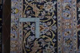Backside of handmade 2000s Kashan rug showing knot structure and weave density