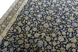 Backside of handmade 2000s Kashan rug showing knot structure and weave density