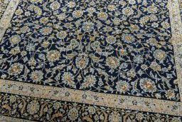 Close-up detail of 2000s Kashan rug from Iran / Persia showing Wool weave