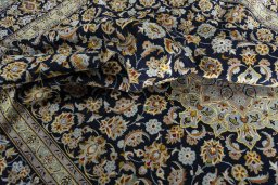 Surface texture of 2000s Kashan rug with natural Wool and intricate pattern