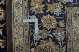 Backside of handmade 2000s Kashan rug showing knot structure and weave density