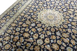 Backside of handmade 2000s Kashan rug showing knot structure and weave density