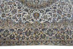 Corner detail of 2000s Kashan rug showing border pattern and Cork pile