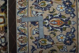 Backside of handmade 2000s Kashan rug showing knot structure and weave density
