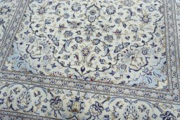 Corner detail of 2000s Kashan rug showing border pattern and Wool pile