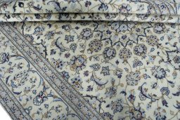 Backside of handmade 2000s Kashan rug showing knot structure and weave density