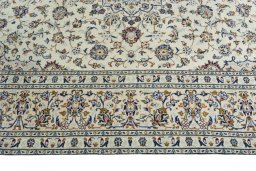 Corner detail of 2000s Kashan rug showing border pattern and Wool pile