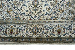 Corner detail of 2000s Kashan rug showing border pattern and Wool pile