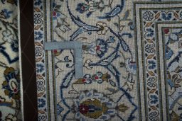 Backside of handmade 2000s Kashan rug showing knot structure and weave density