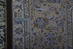 Backside of handmade 2000s Kashan rug showing knot structure and weave density