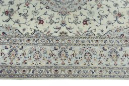 Corner detail of New Kashan rug showing border pattern and Wool pile