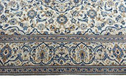 Corner detail of 2000s Kashan rug showing border pattern and Wool pile
