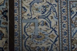 Backside of handmade 2000s Kashan rug showing knot structure and weave density