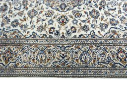 Corner detail of 2000s Kashan rug showing border pattern and Wool pile