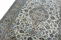 Backside of handmade 2000s Kashan rug showing knot structure and weave density